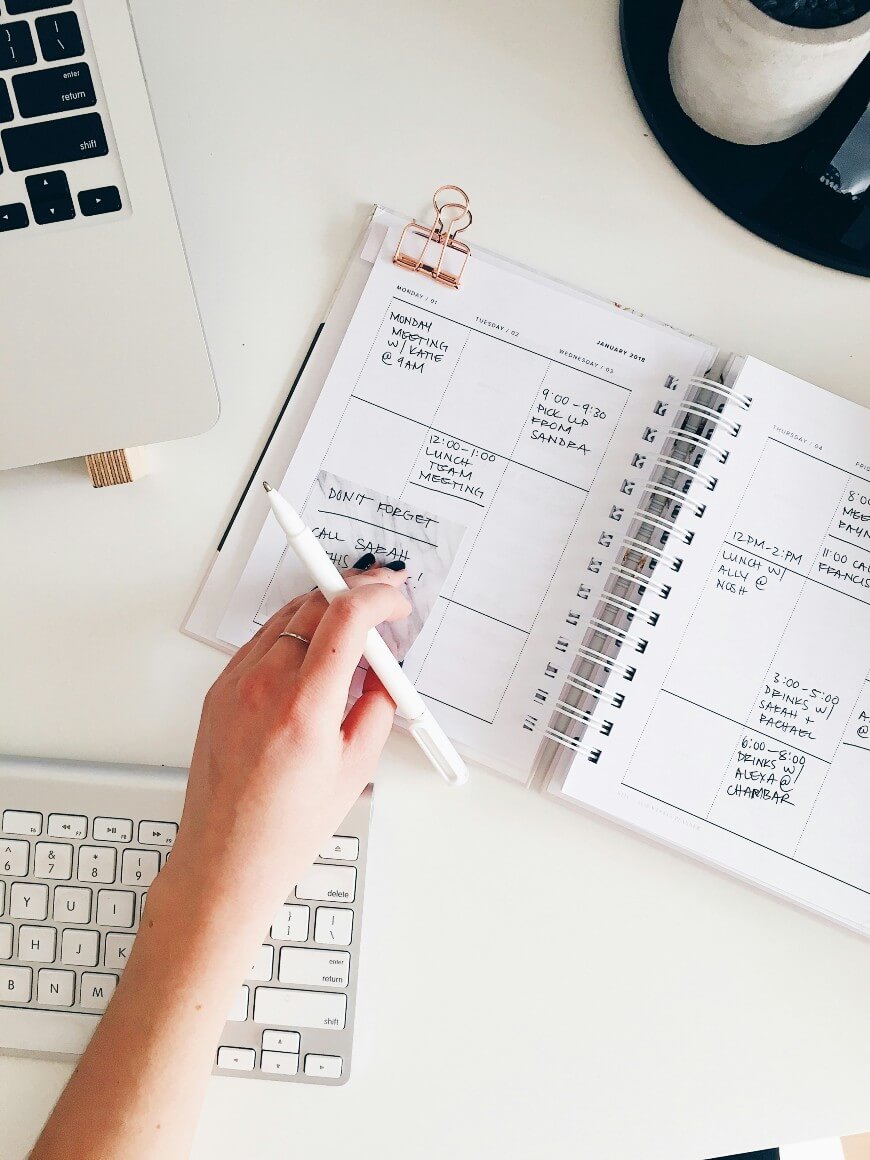 woman writing in her work diary