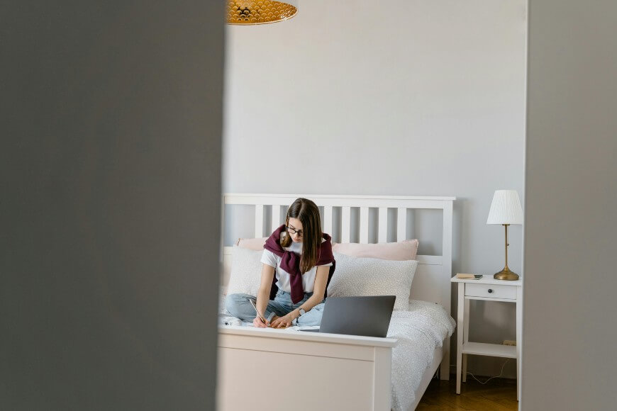 teenager studying in a clean bedroom