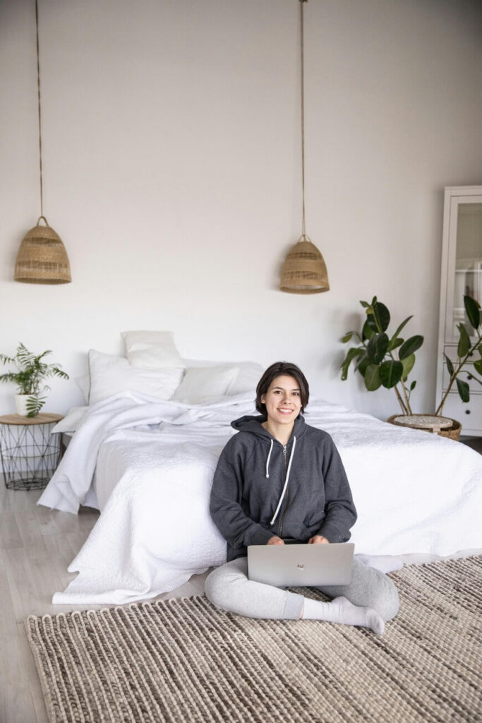 teenager sitting in a tidy bedroom