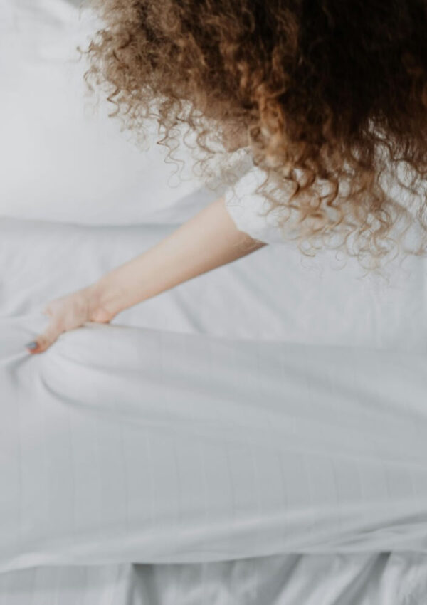 teenage girl making a bed