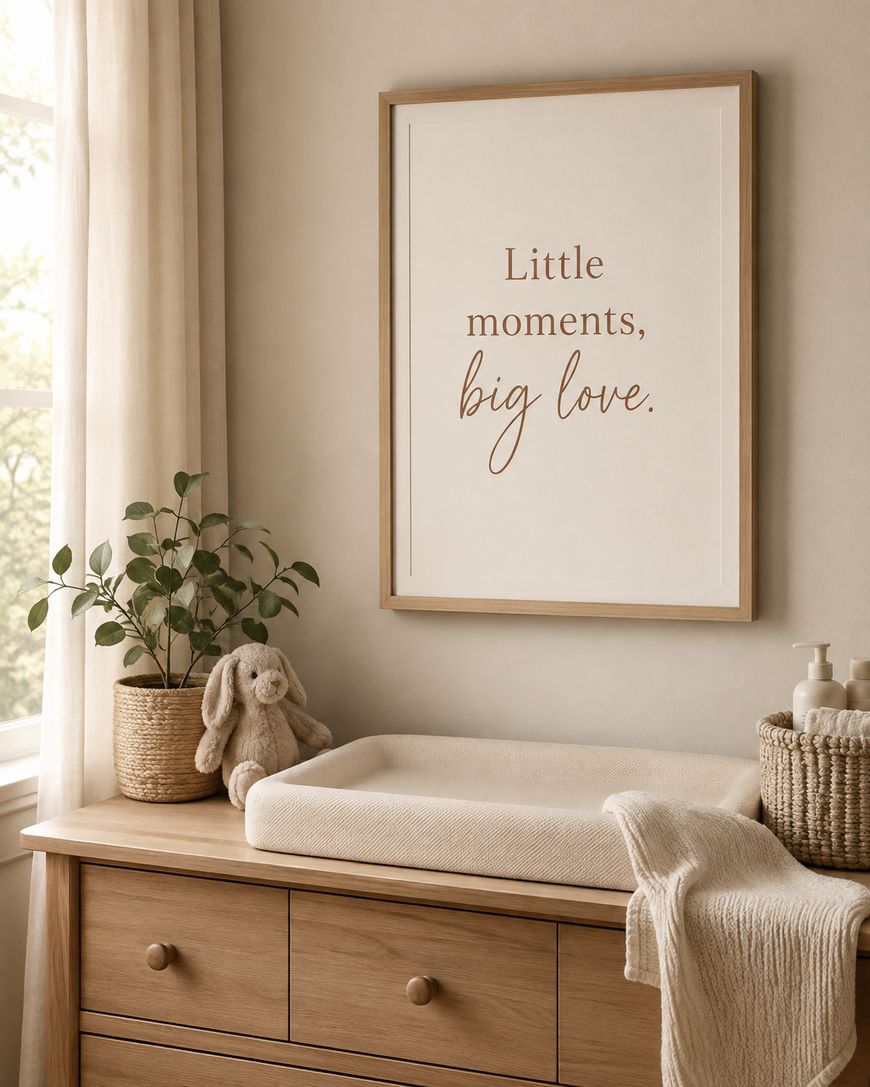 A framed print on a wall above a console table with trailing greenery.